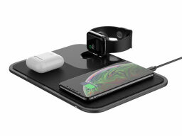Smartwatch, Airpods, and plugged-in phone on black charging pad