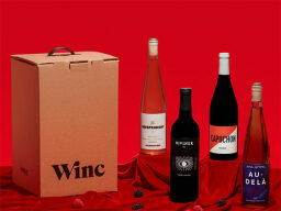 Four possible wine bottles you could get from Winc on a read background.