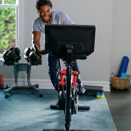 Man riding a Bowflex indoor cycling bike.