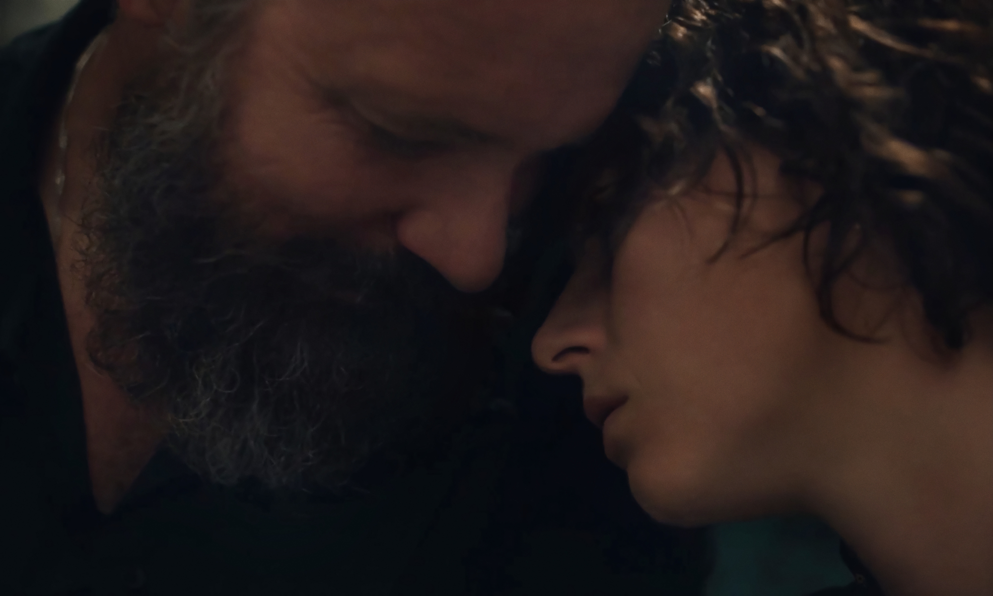 Peter Saarsgard and Jessie Buckley snuggled in "The Lost Daughter."