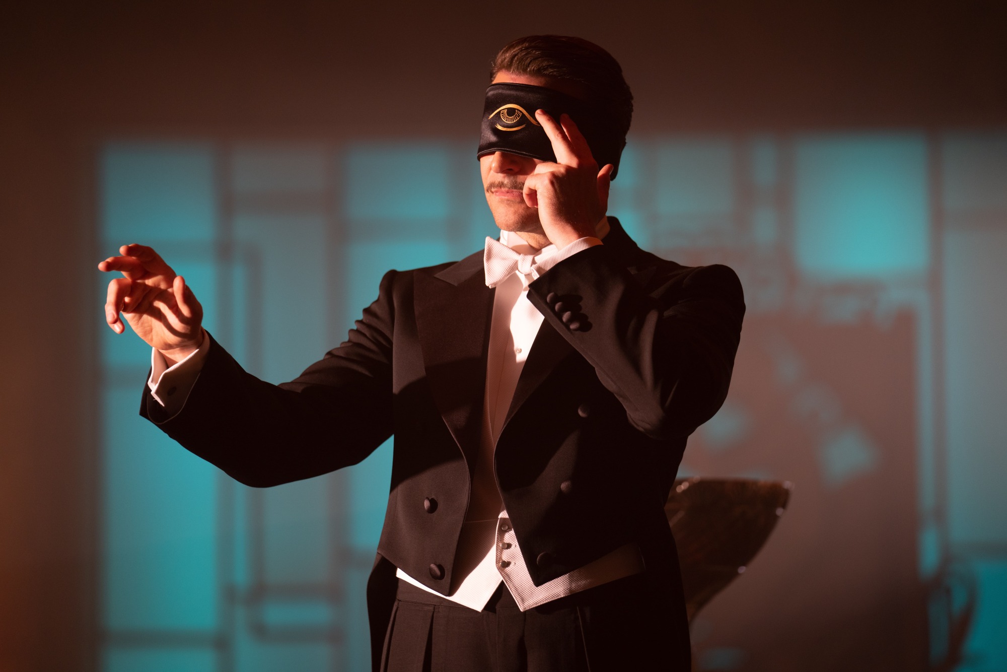 Bradley Cooper has a blindfold on while onstage in "Nightmare Alley."