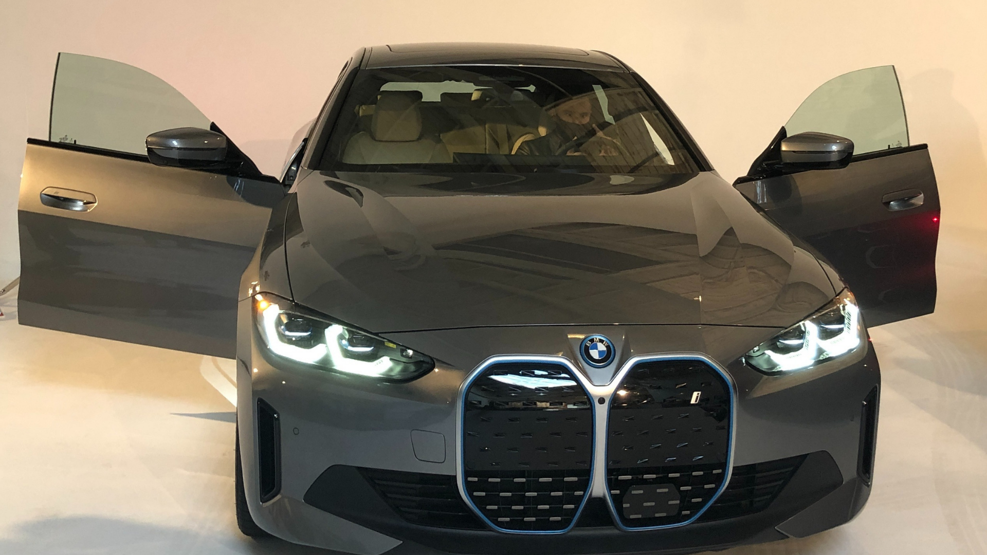 Gray car with front doors open.