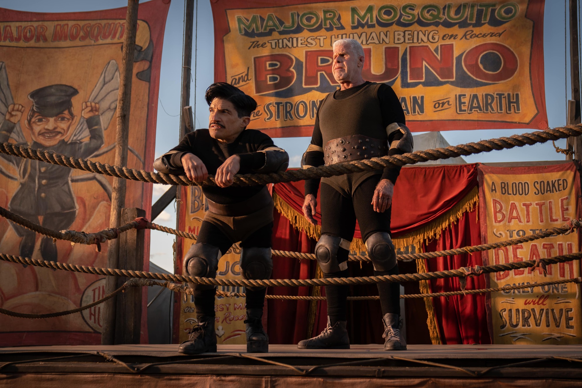 Ron Perlman and Mark Povinelli stand in a wrestling ring in "Nightmare Alley."