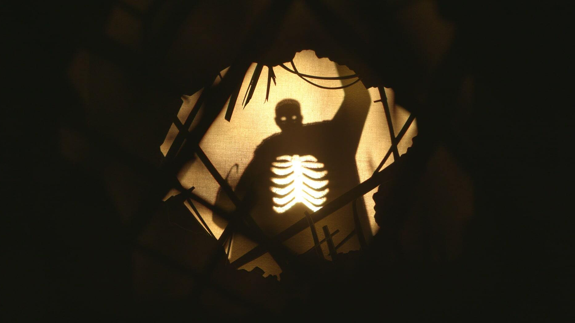 A shadow puppet of a man with a hook for a hand.