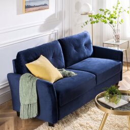 blue couch in living with blankets draped over it