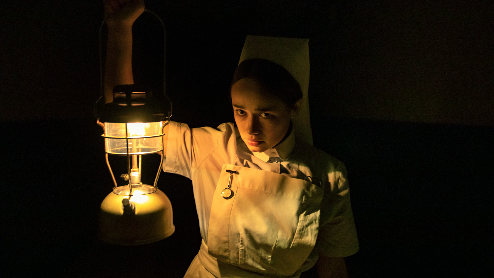 A nurse peers into the dark in "The Power" film.