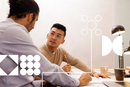 two guys in a meeting with graphic white designs and shapes over it