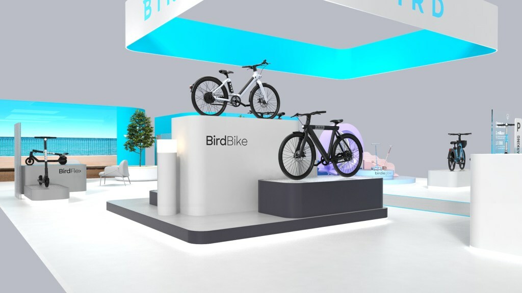 A display of bikes in a white room with a turquoise light.