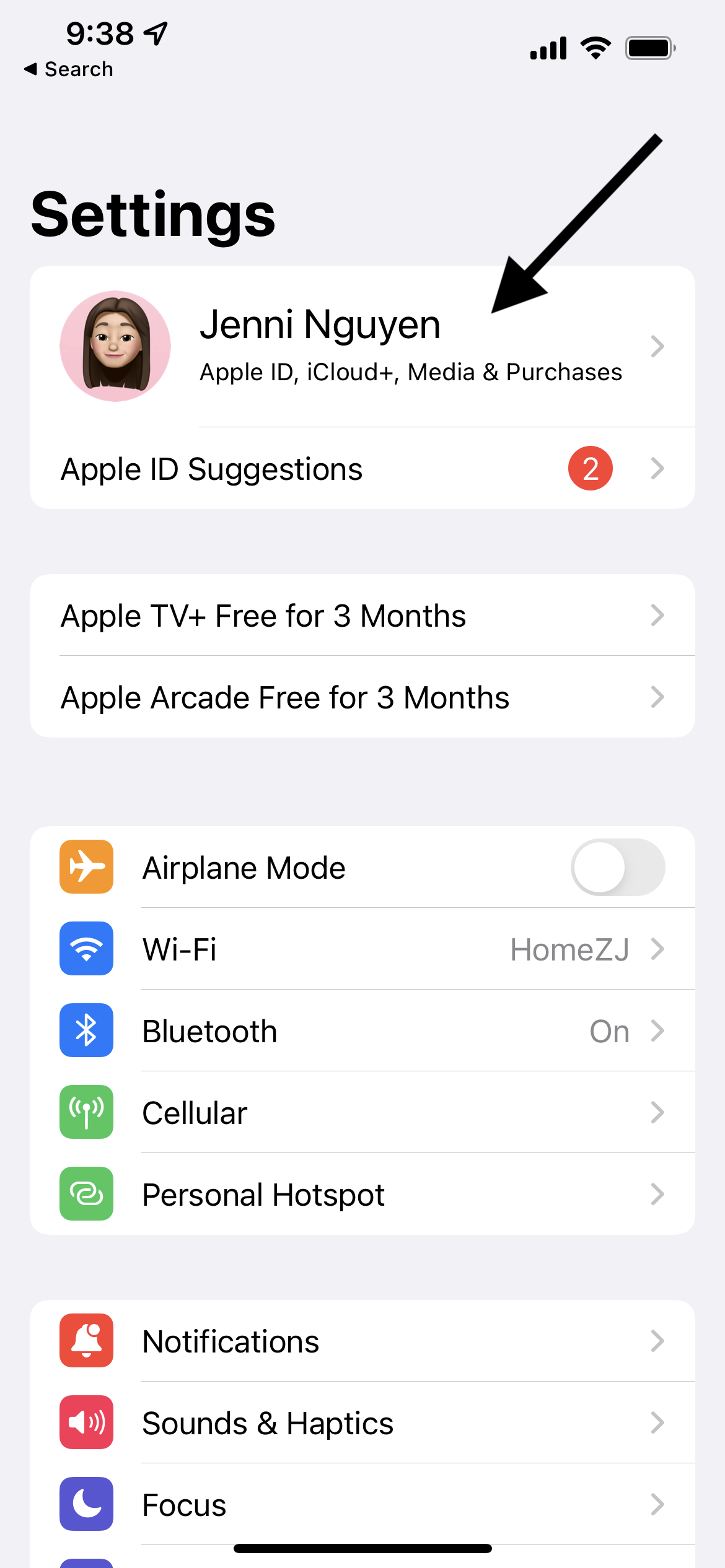 Screenshot of the Settings menu of an iPhone, with an arrow pointing to user's name at top.