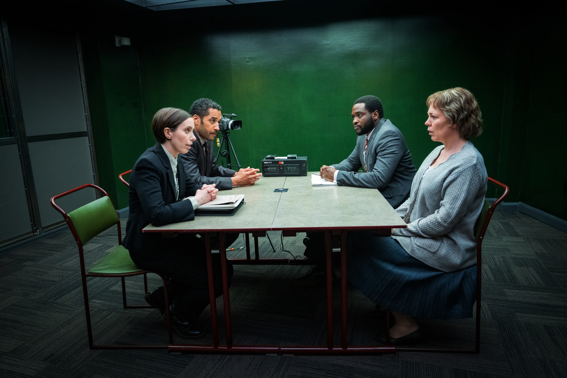 Four actors — Samuel Anderson, Kate O'Flynn, Dipo Ola, Olivia Colman — around a police interrogation table in "Landscapers."