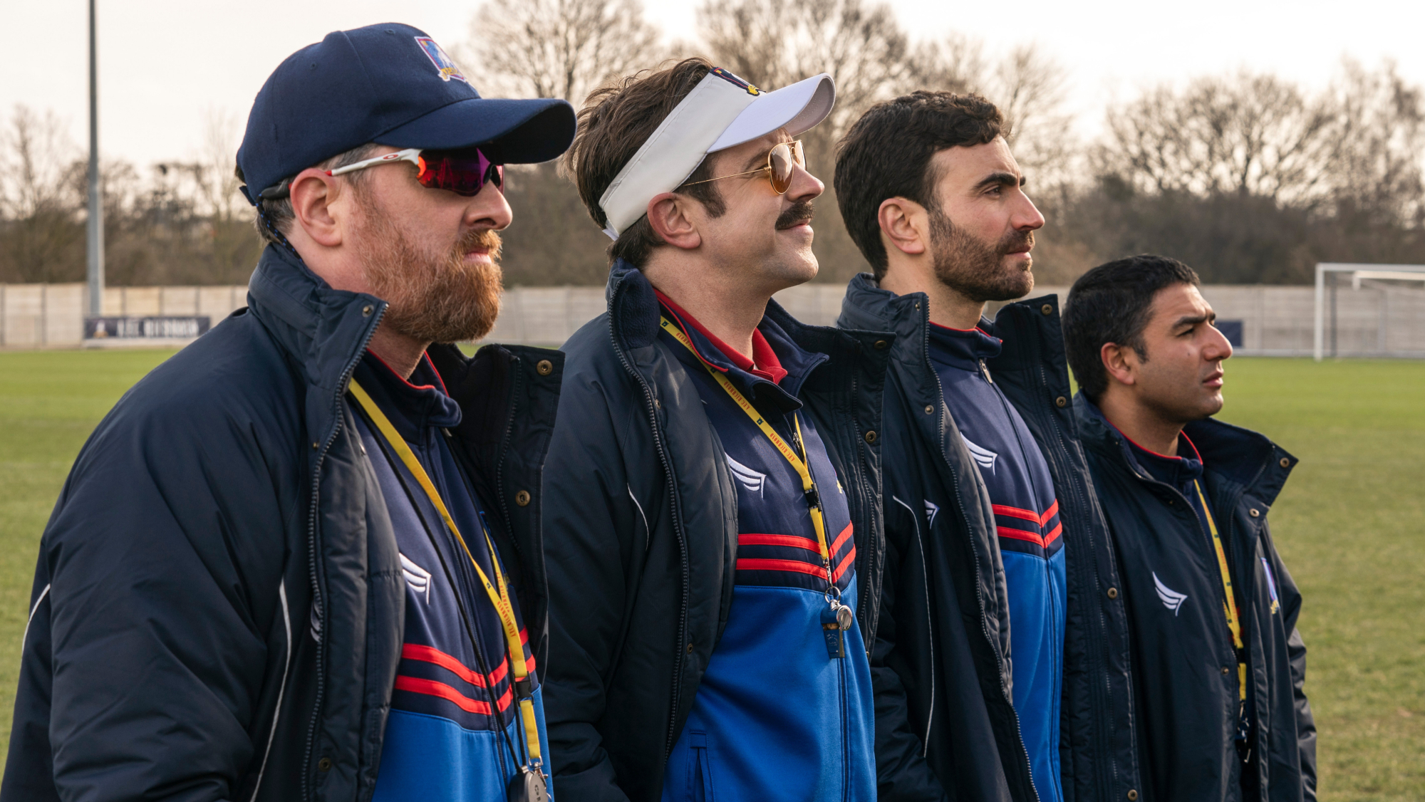 Four men in matching coaching uniforms