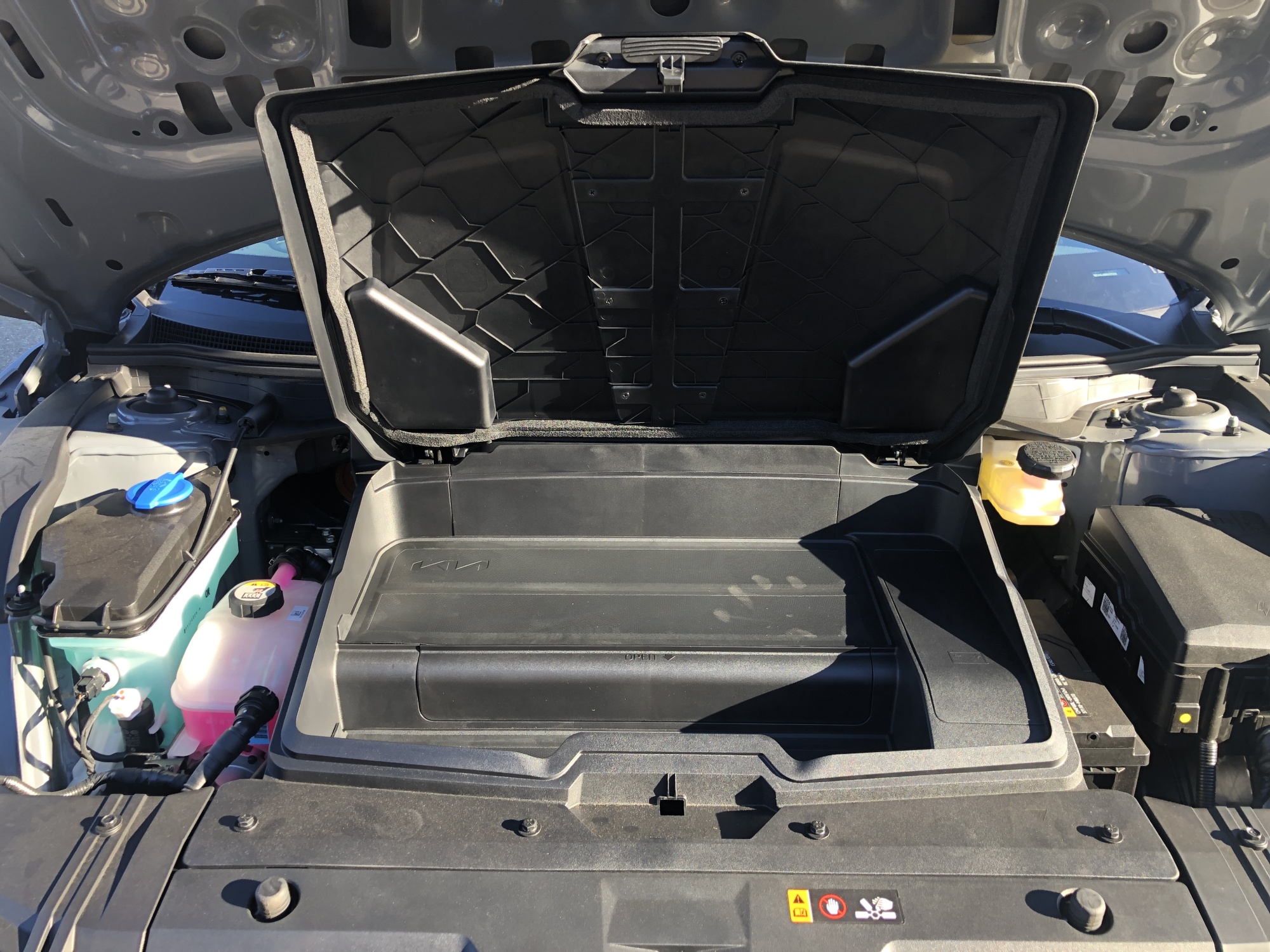 Open frunk under the hood of the EV.