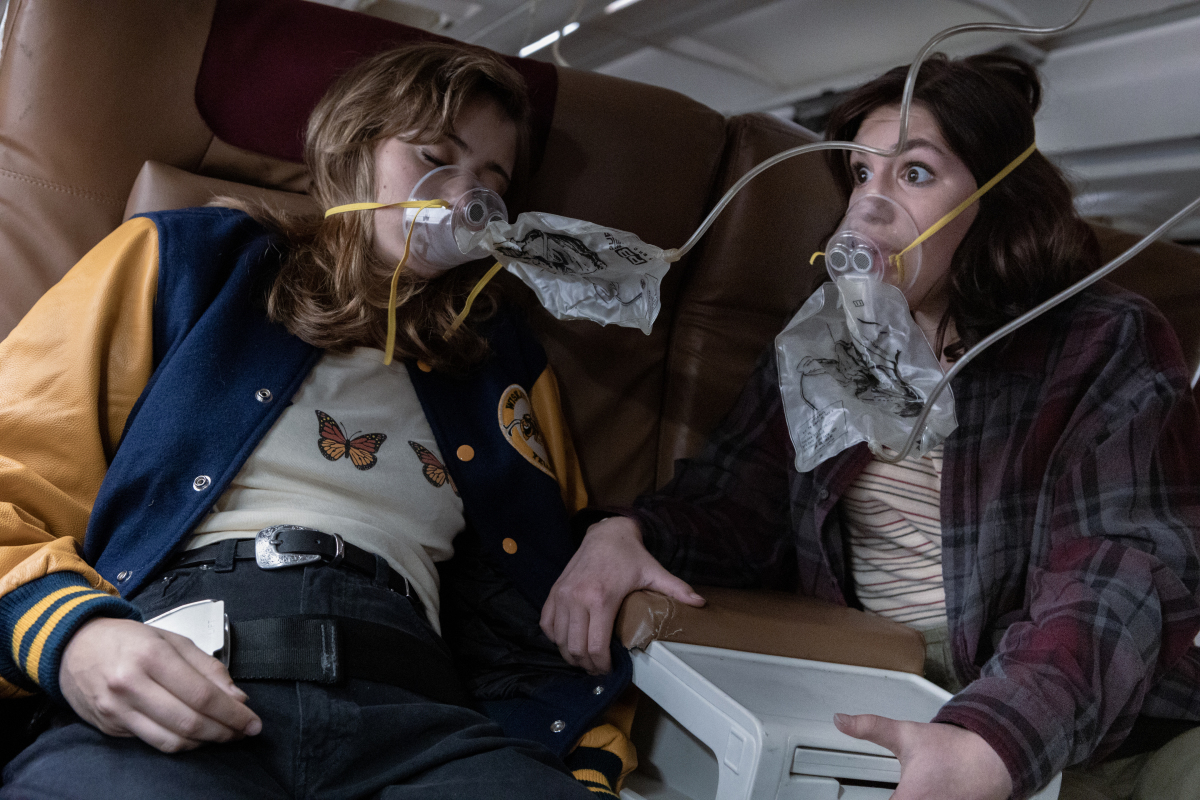 Two teenagers wearing oxygen masks as their plane goes down - a still from "Yellowjackets."