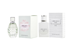 Two perfume bottles next to white boxes