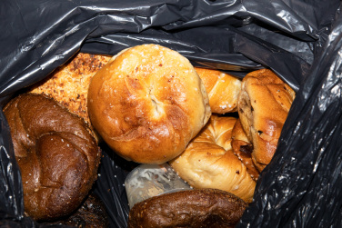 garbage bag containing multiple bagels