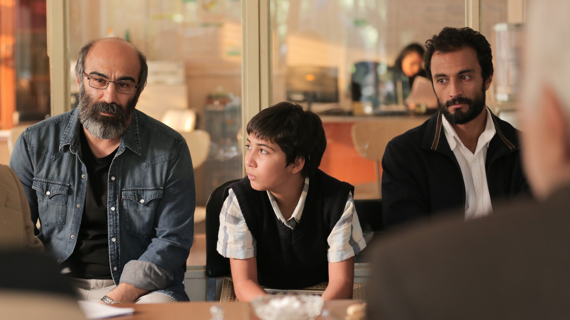 Barahm (Mohsen Tanabandeh), Siavash (Saleh Karimaei), and Rahim (Amir Jadidi) sitting beside each other.