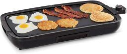 Electric griddle with breakfast foods on it