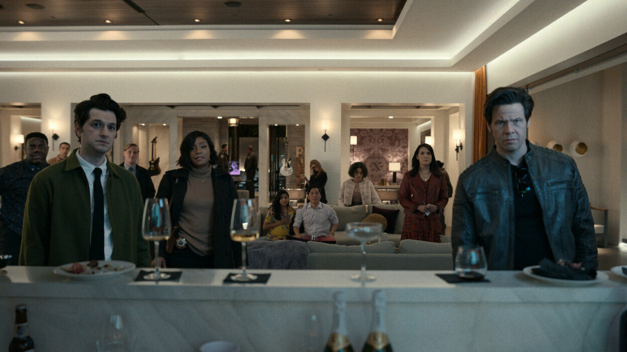 A group of party goers look concerned.