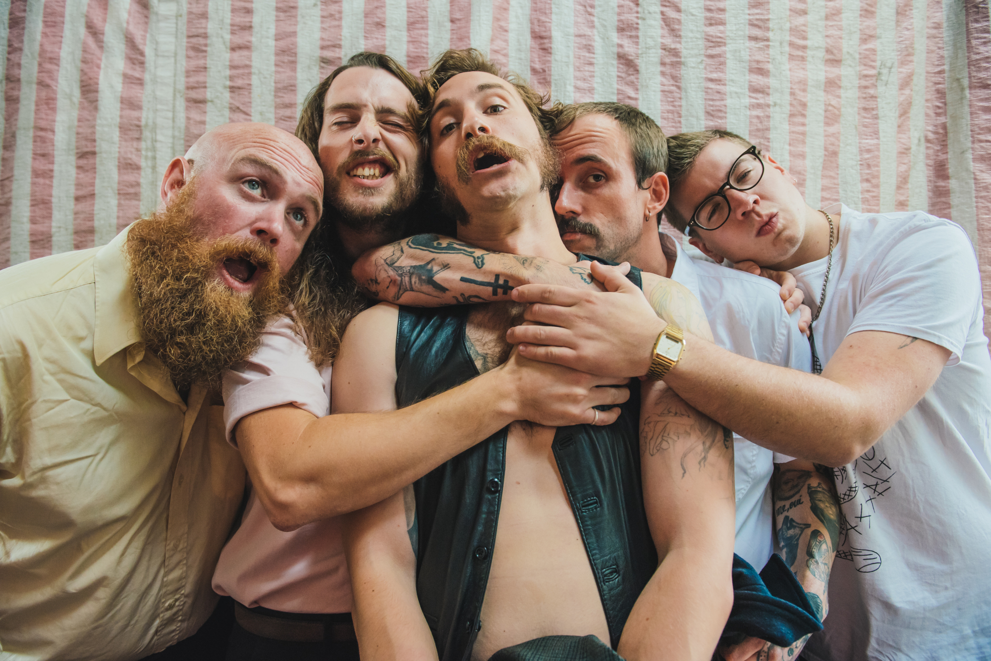 The memberss of Idles, hugging
