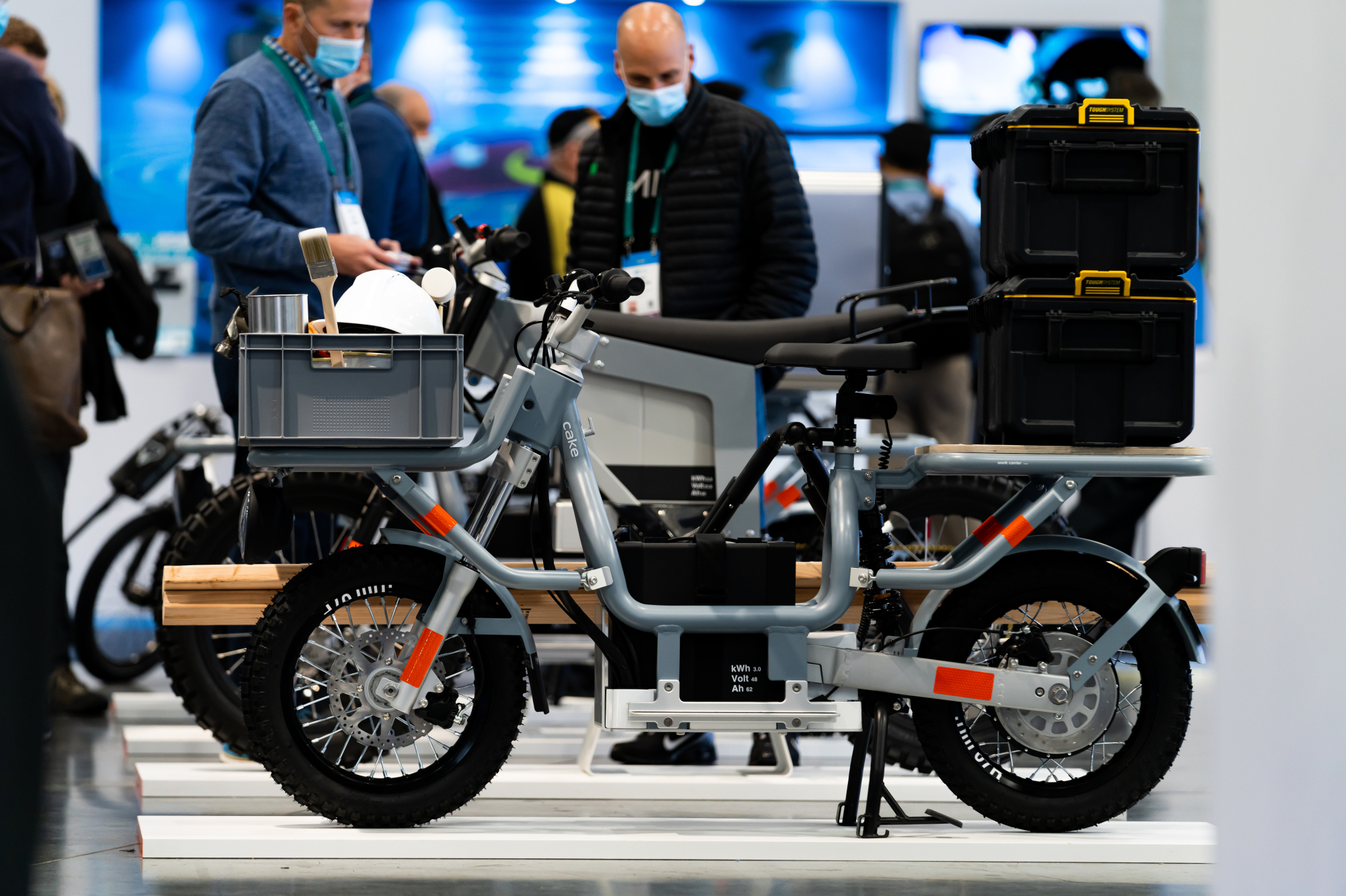 A gray utility e-bike on display at a booth.