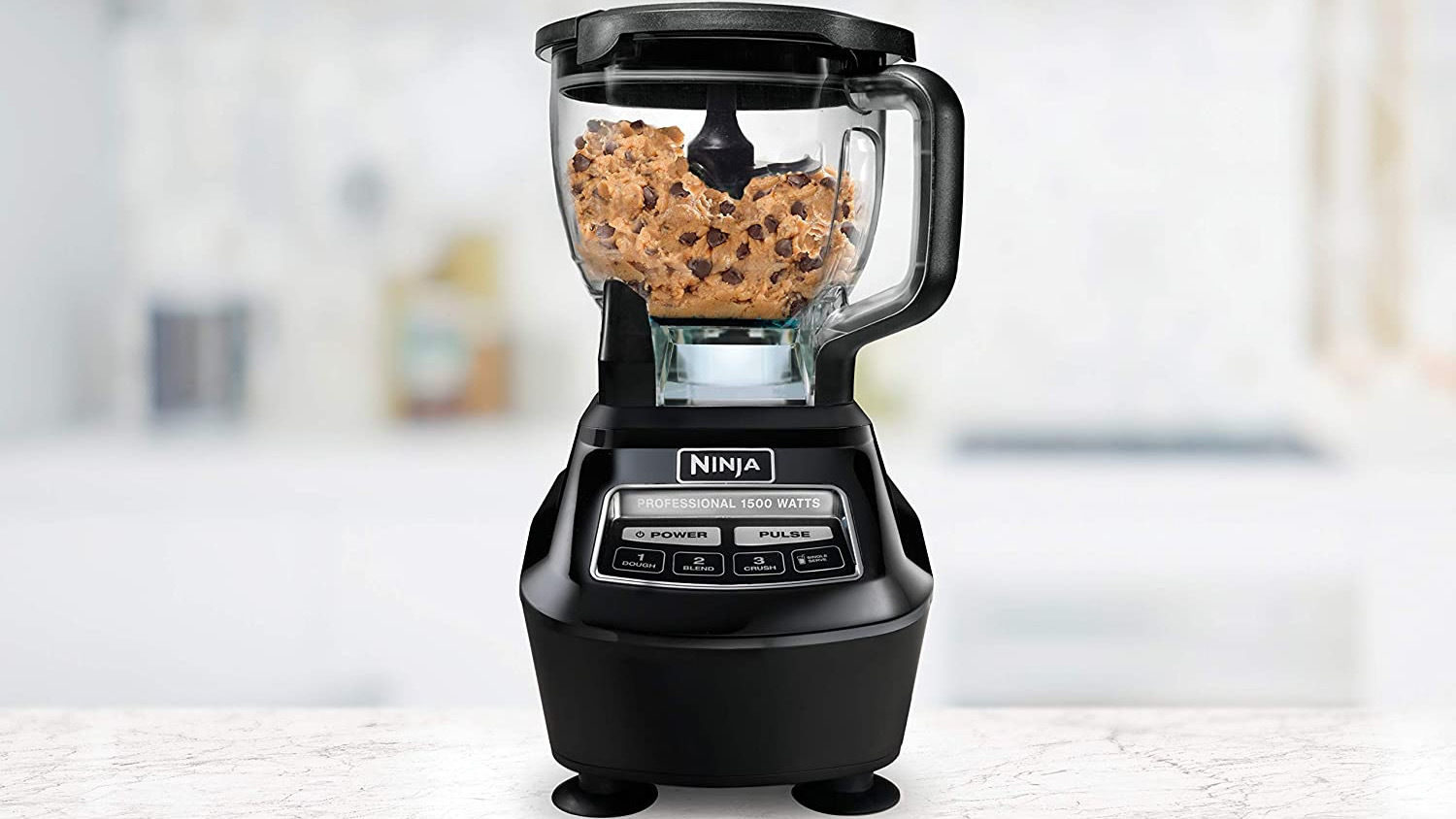 Black ninja food processor with cookie dough in it 