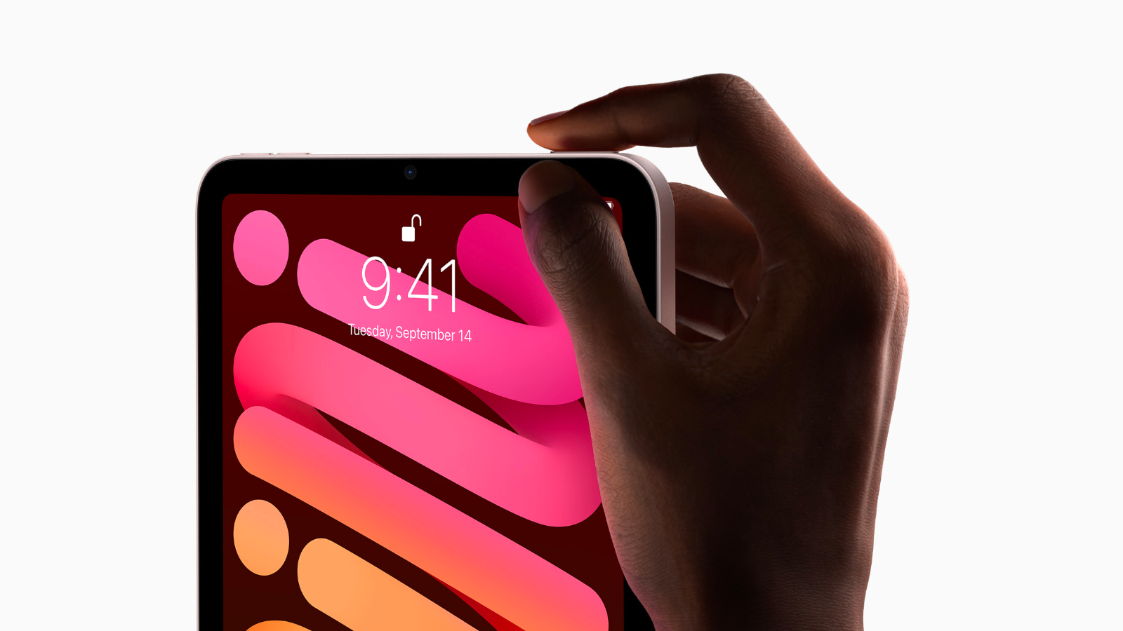 close-up of a person pressing the top button of an ipad mini