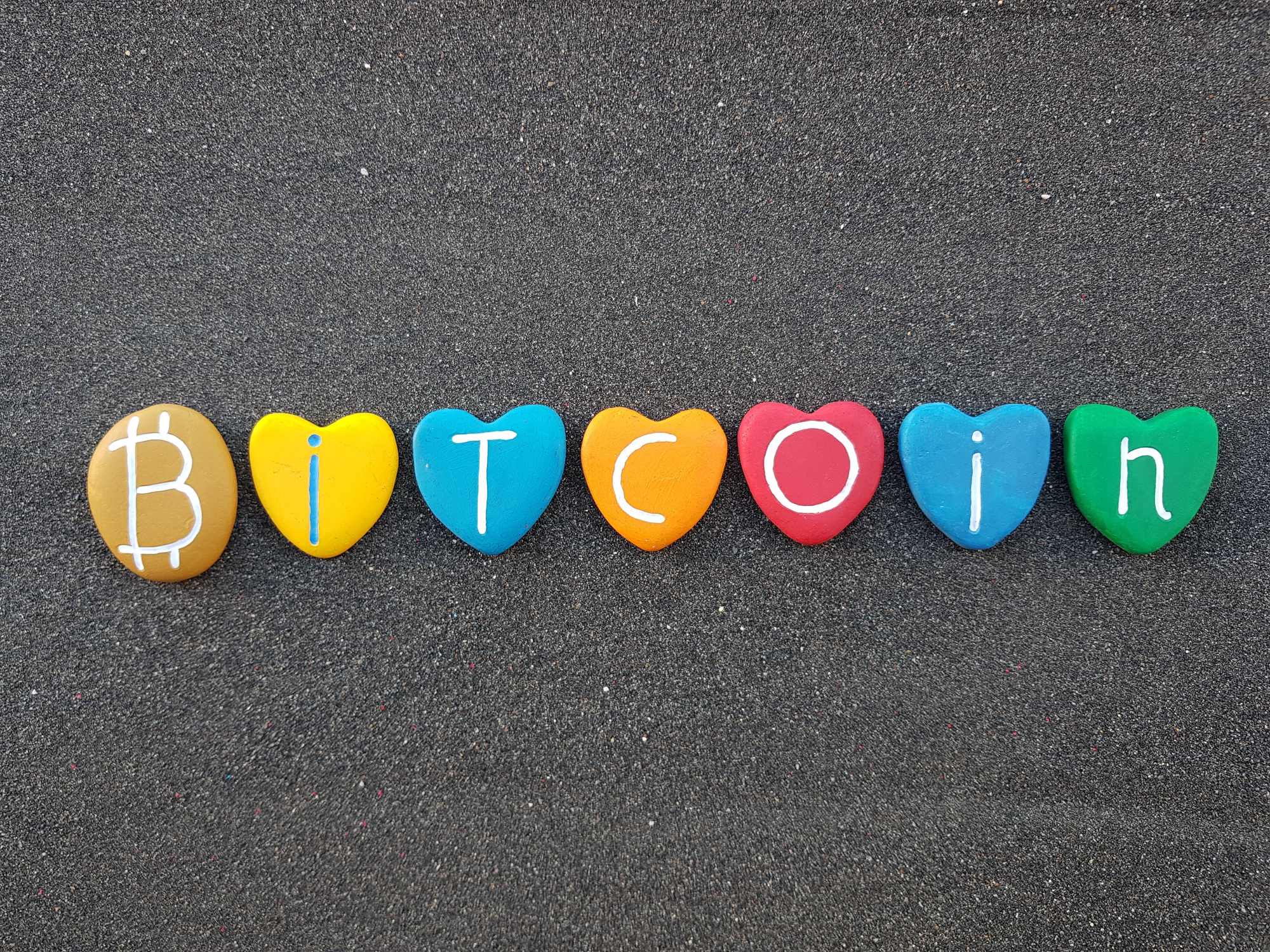 Clay hearts on the sidewalk spelling out the word
