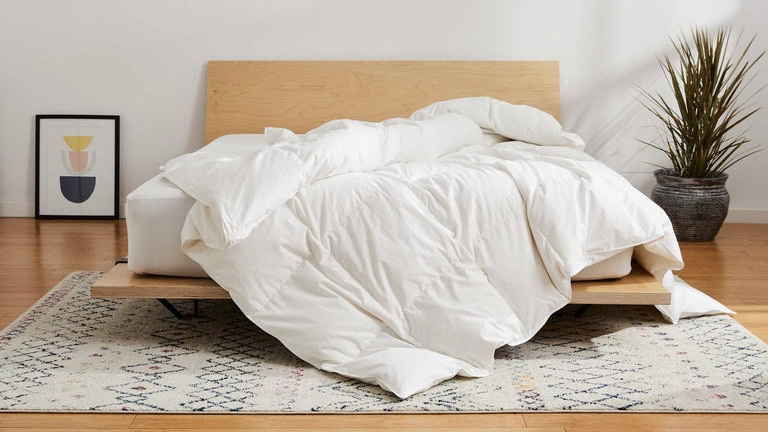 unmade bed with a down comforter