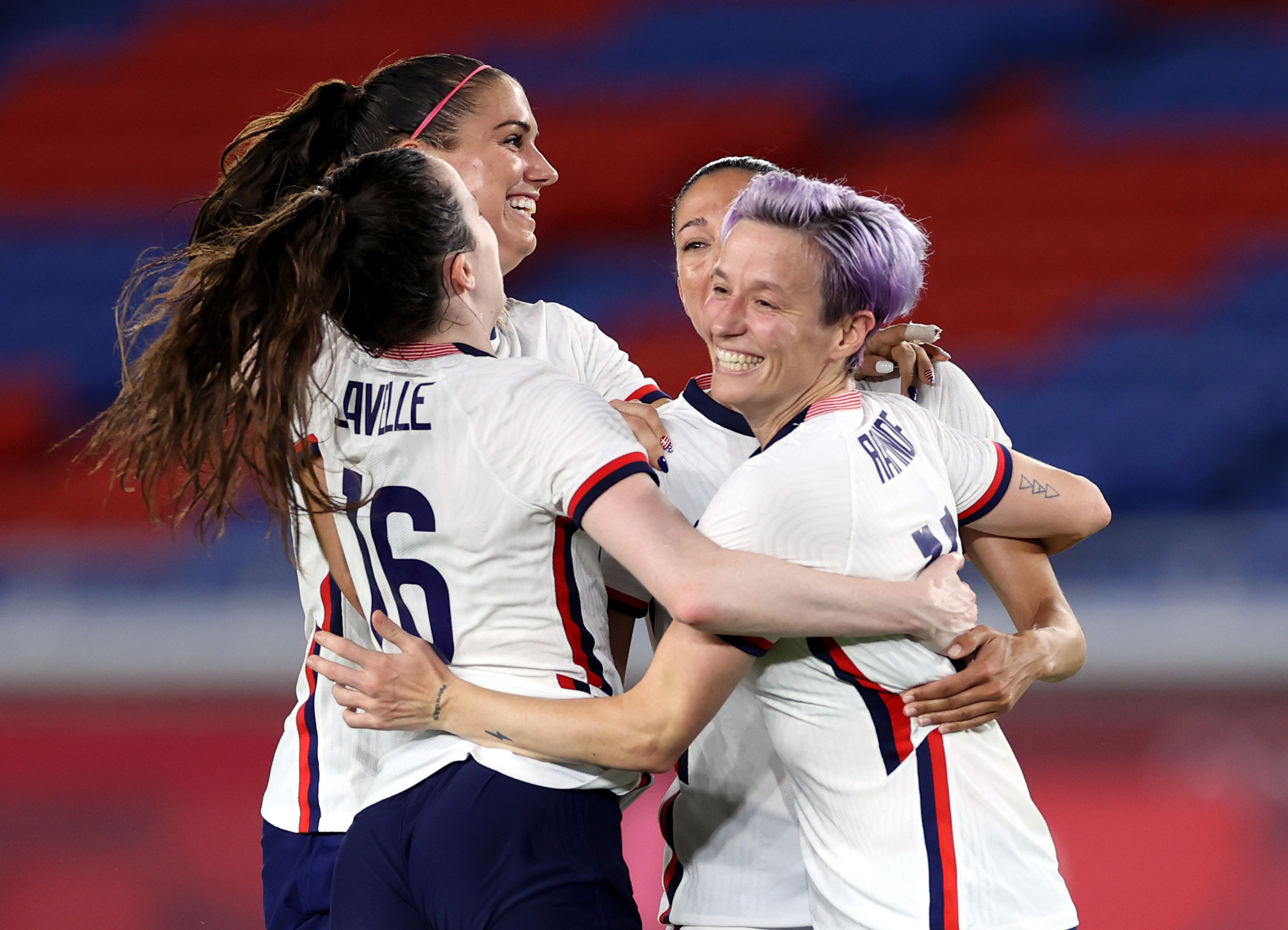 Members of the U.S. Women's National Team embrace after a soccer match.