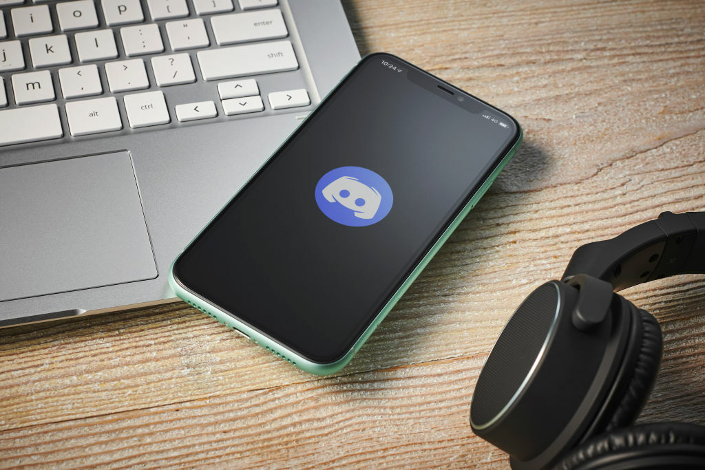 A photo of a Discord logo on a smartphone.