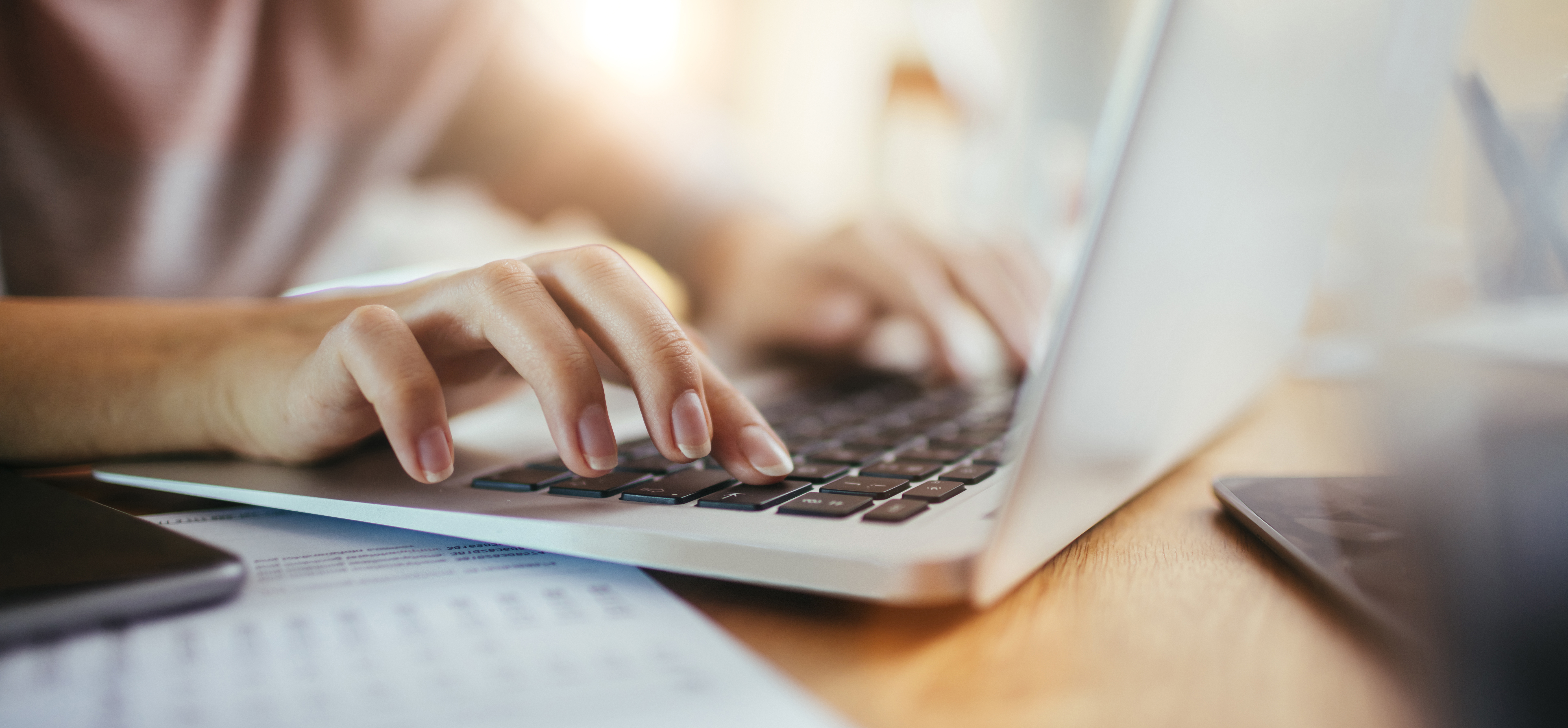 A person types on a laptop.
