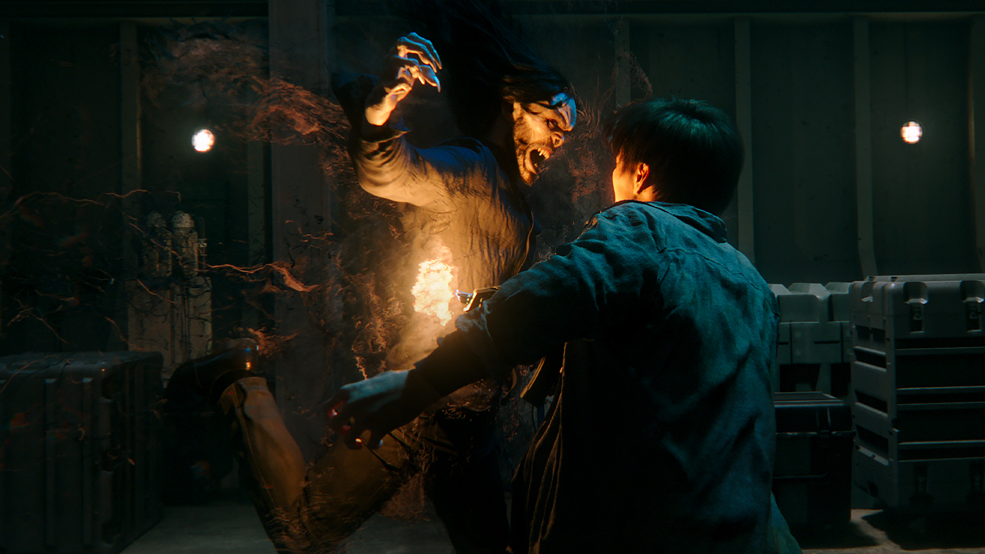 A vampiric creature with pale skin, long black hair, and claws attacks a man in a warehouse.