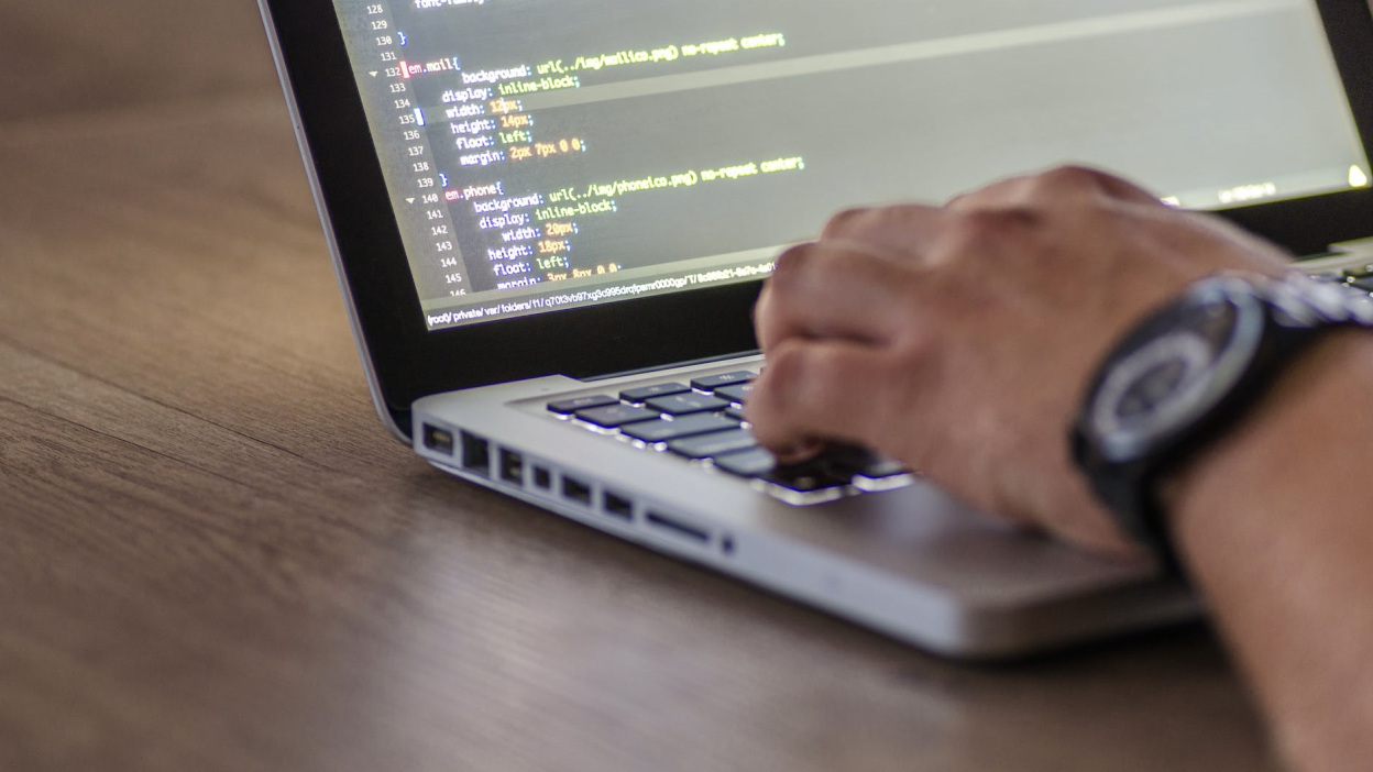 Hand on laptop