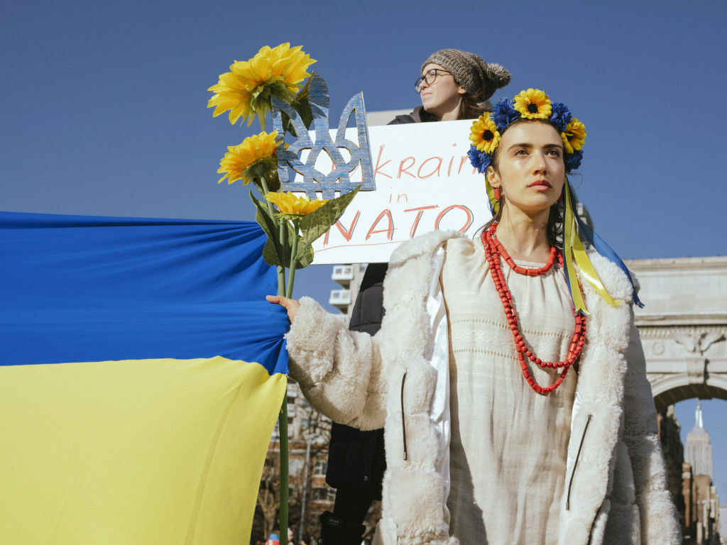 A woman holds sunflowers in Ukraine