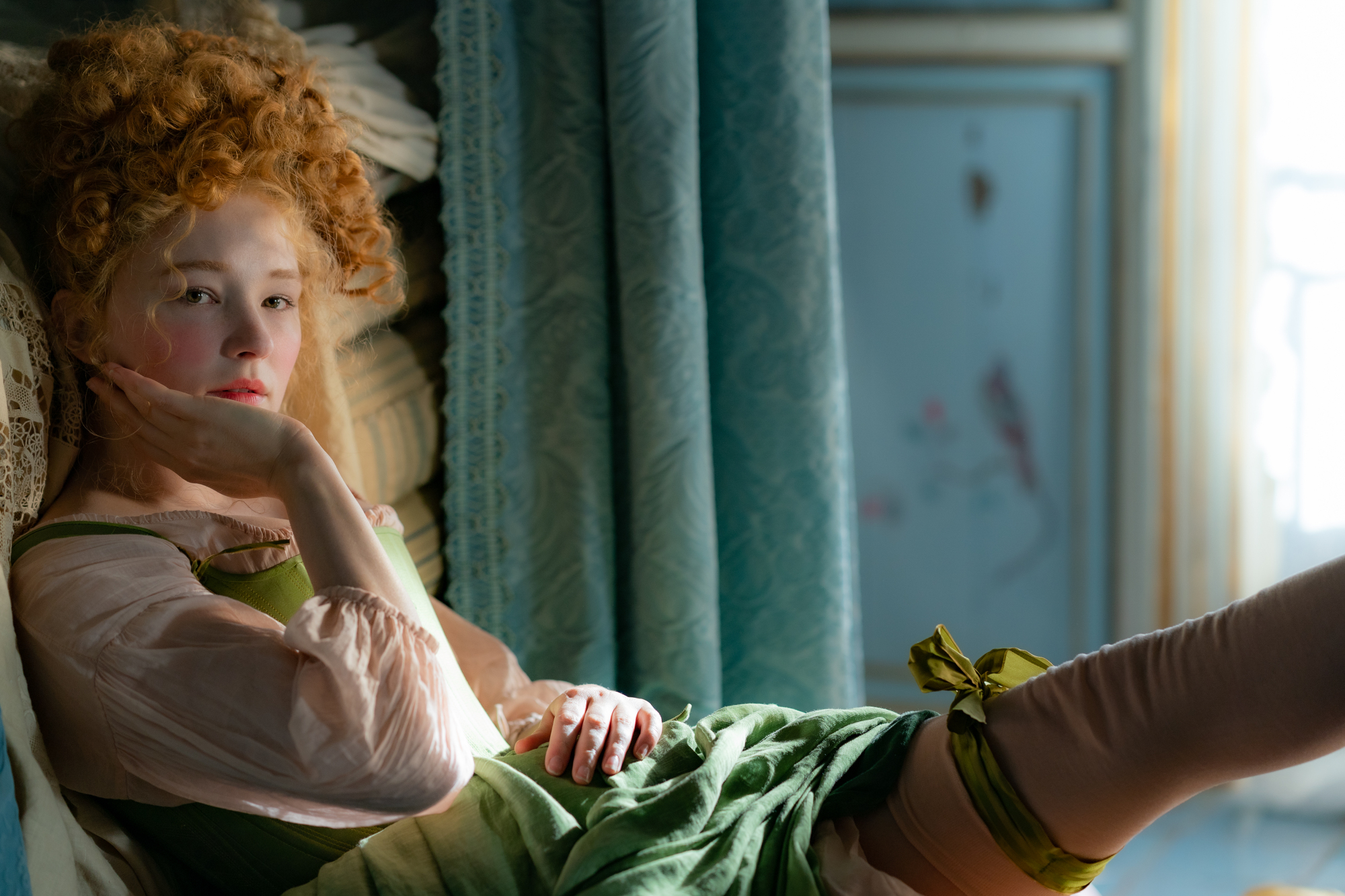 Haley Bennett shows off her stockings while lounging in "Cyrano." 