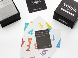 Stack of cards from the voting game with black packaging box next to it