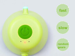 Green circular cat toy with power button and light