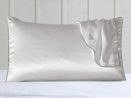 White silk pillow with pillowcase draped over it