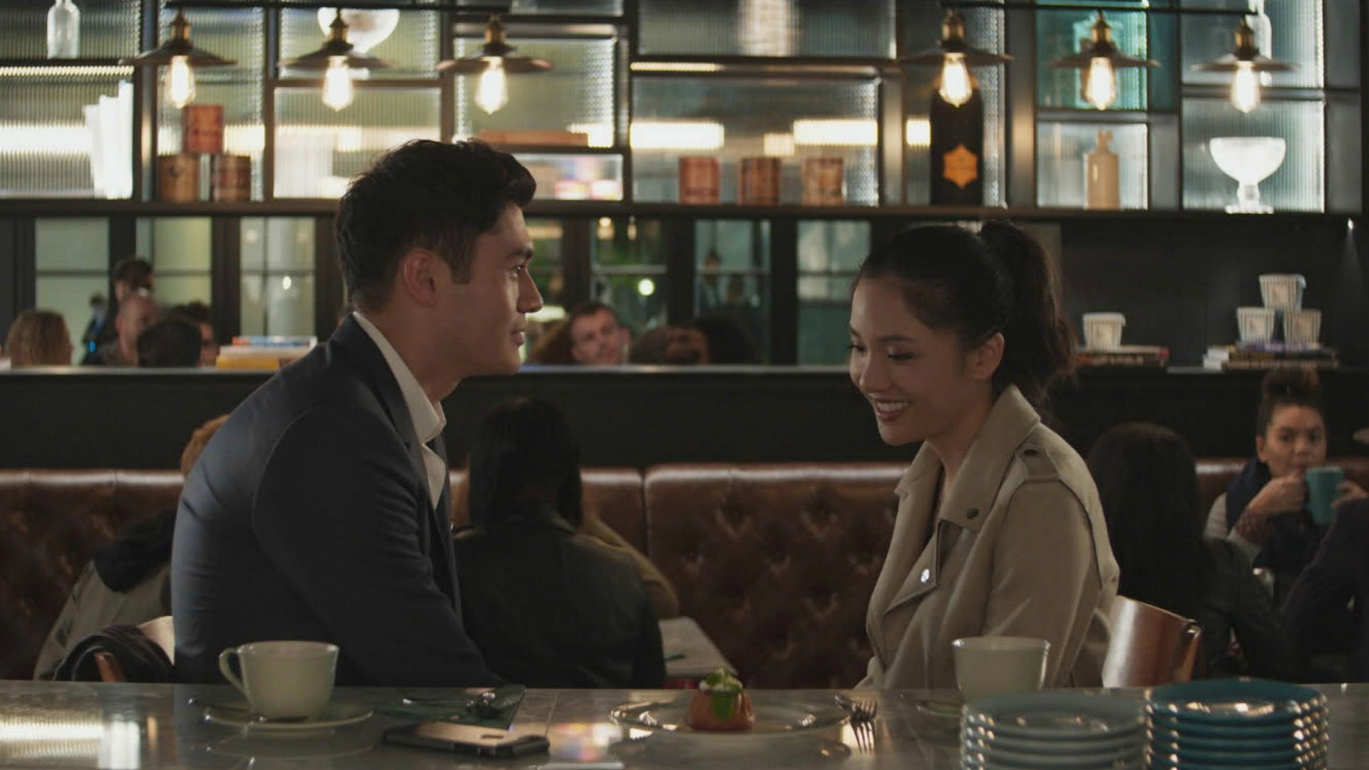 A man and woman sit at a bar