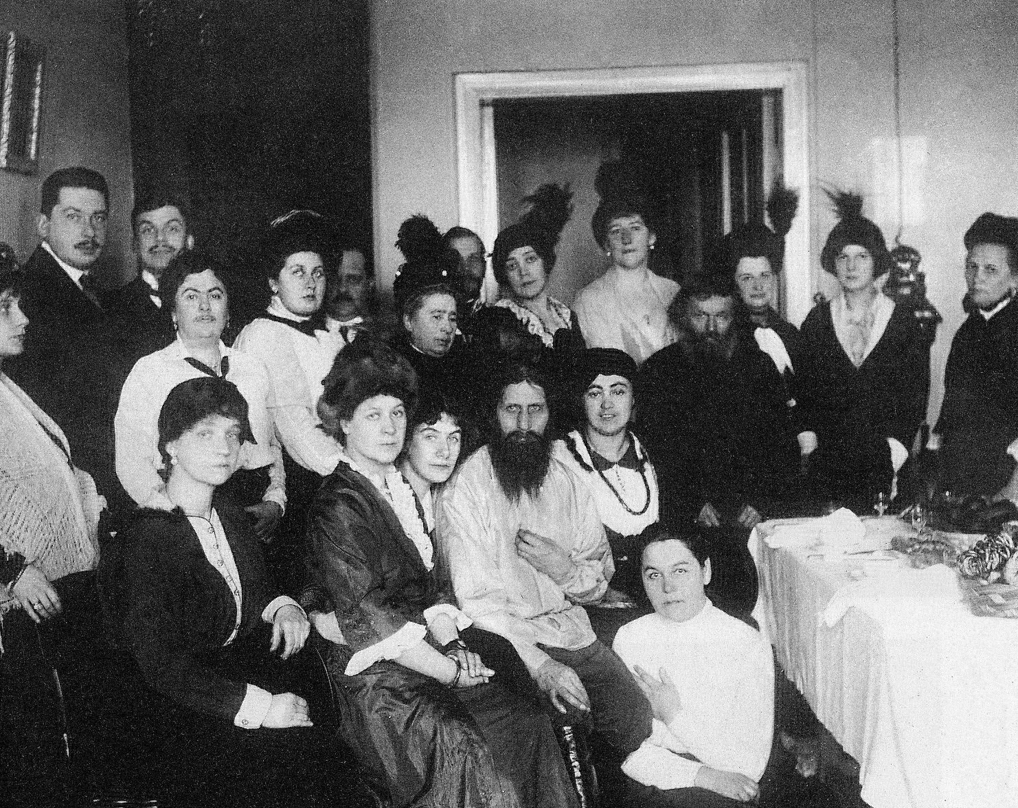 Black and white image of Rasputin surrounded by a group of mostly women