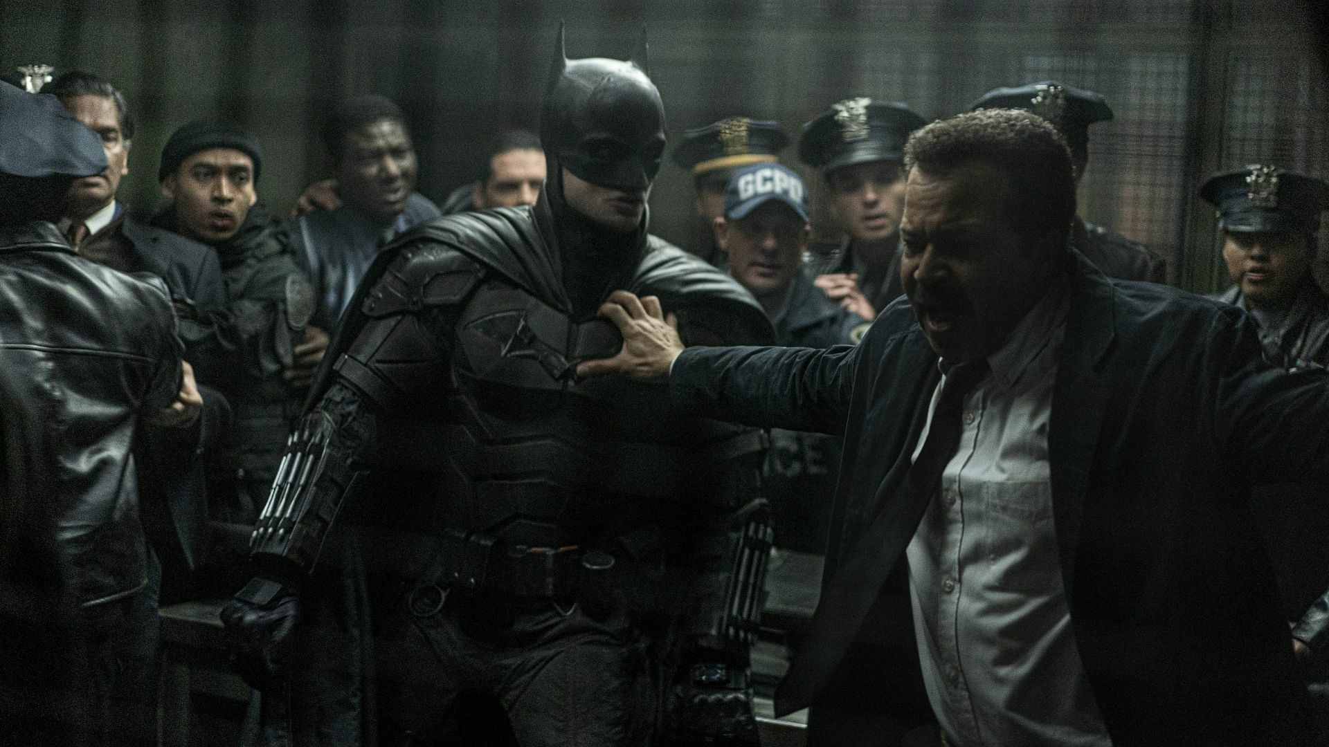Batman surrounded by cops.