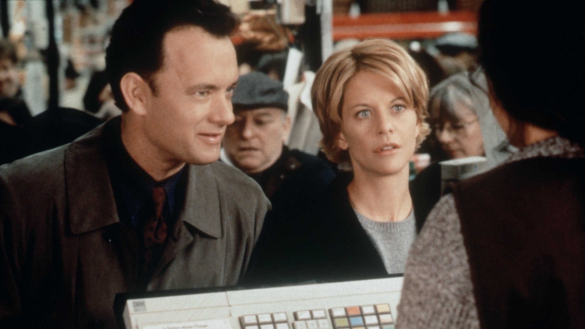A man and woman wait in a customer service line
