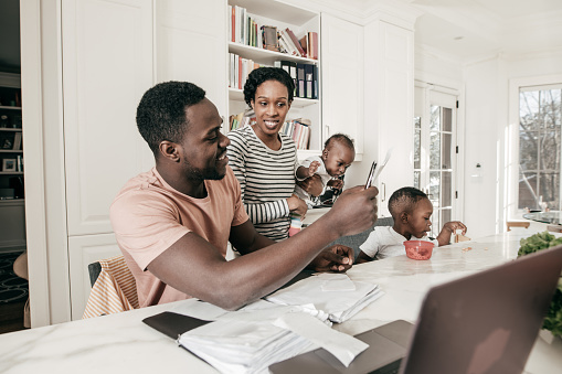 A couple studying their finances with children