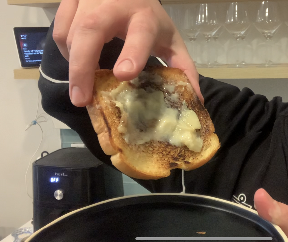 buttery toast picked up over plate