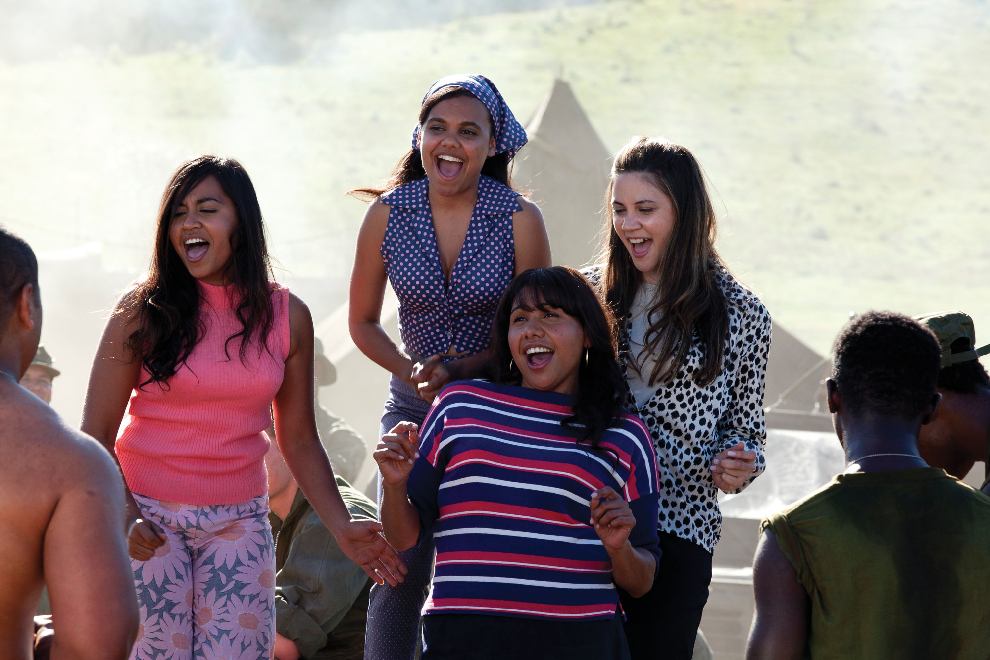 The cast of The Sapphires, four Australian First Nations young women laughing.