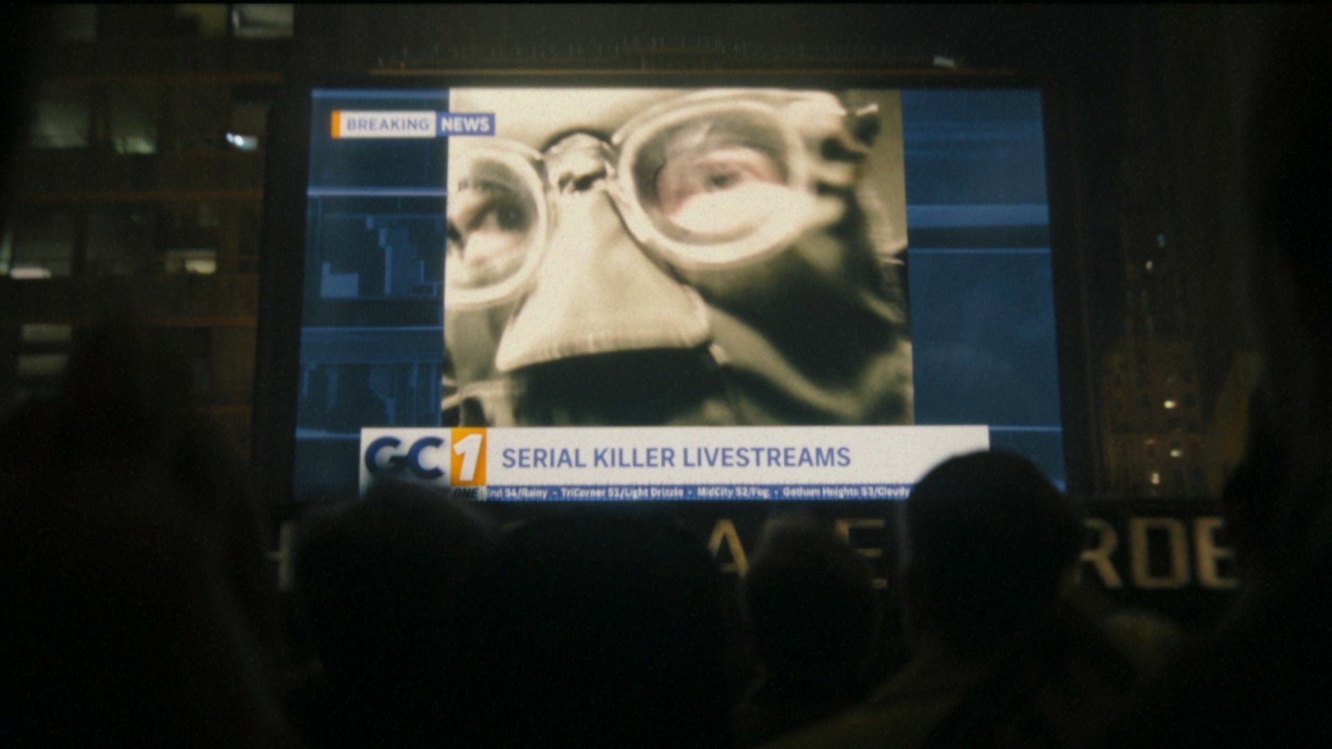 The Riddler on TV news broadcast.