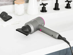 Grey hair dryer on washroom countertop