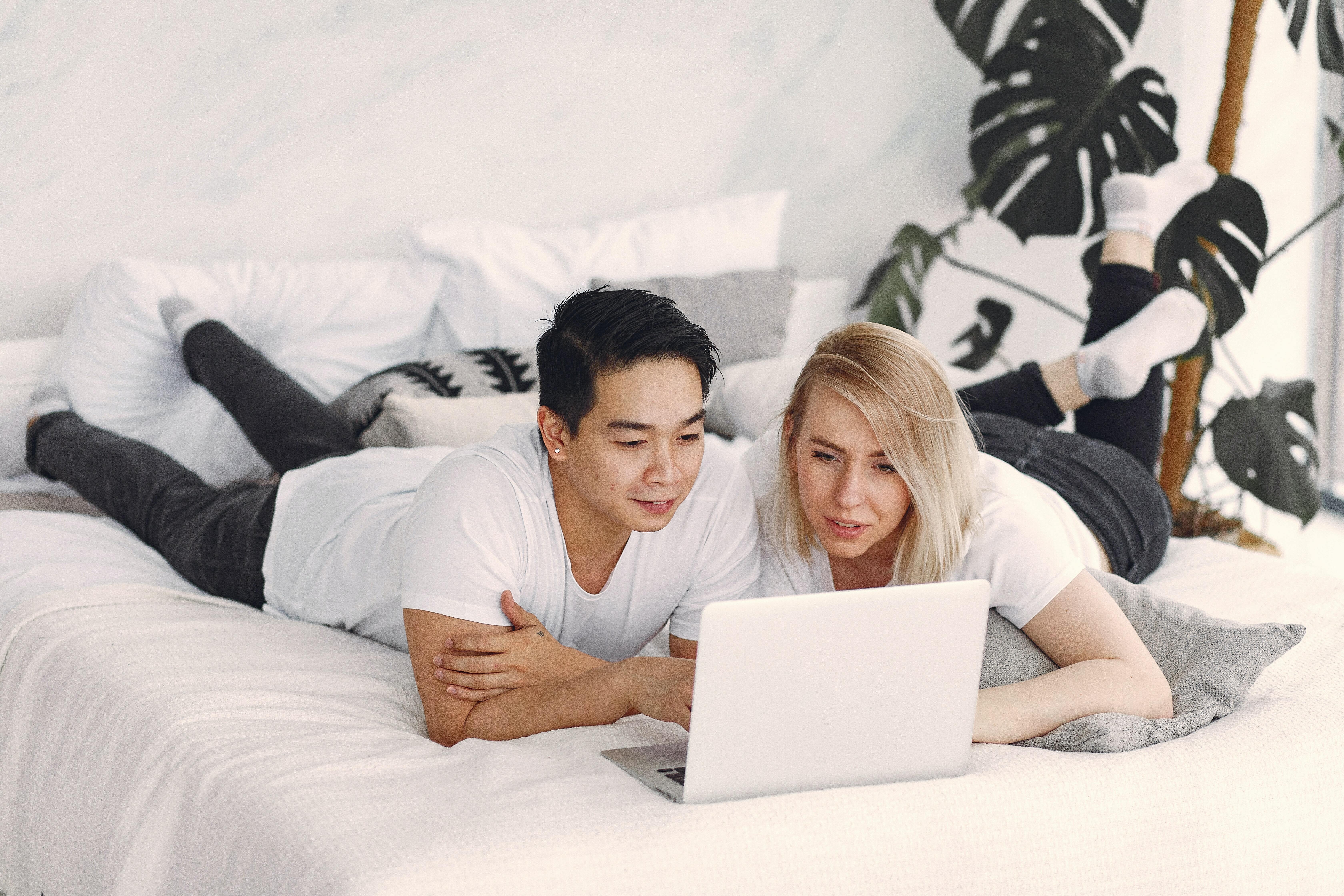 Couple staring at laptop