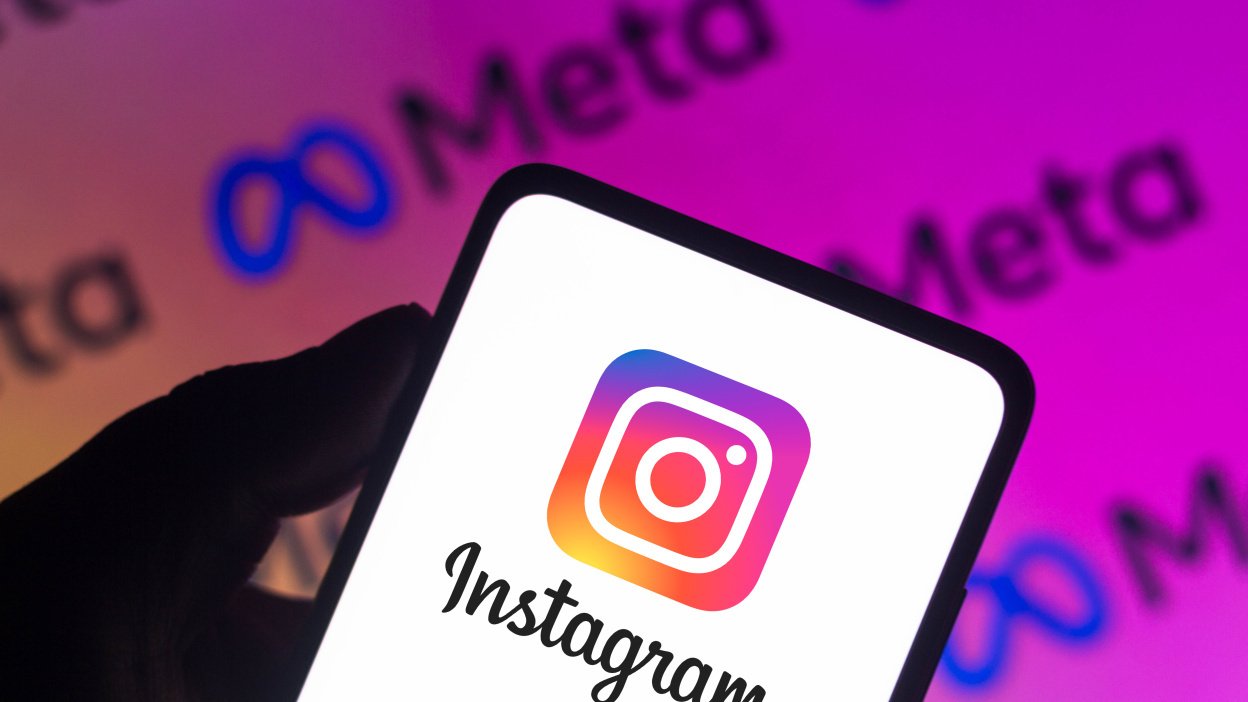 A phone with the Instagram logo, against a background with 