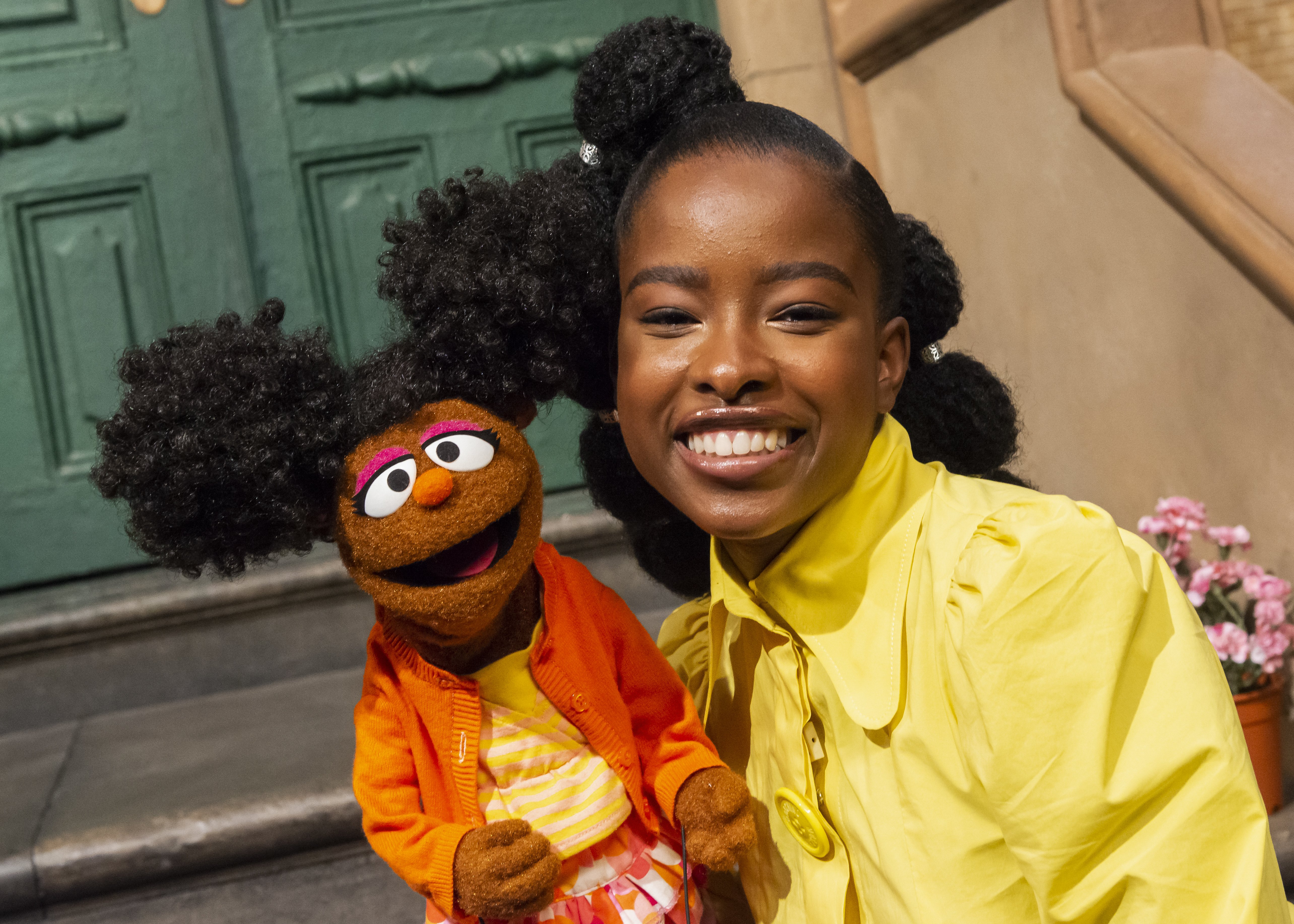 Image of Amanda Gorman with Sesame Street character Gabrielle